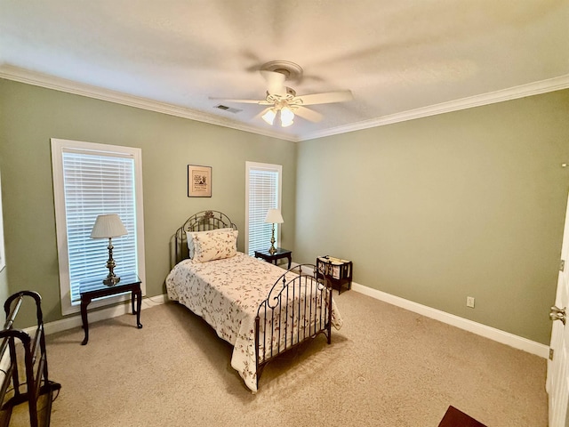 carpeted bedroom with crown molding and ceiling fan