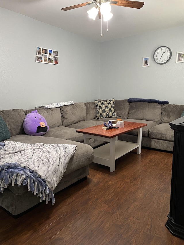 living room featuring dark hardwood / wood-style floors and ceiling fan