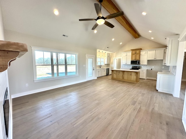 kitchen with a kitchen island, white cabinetry, stainless steel appliances, beam ceiling, and light hardwood / wood-style flooring