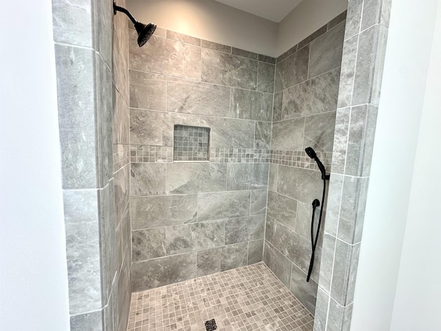 bathroom with tiled shower