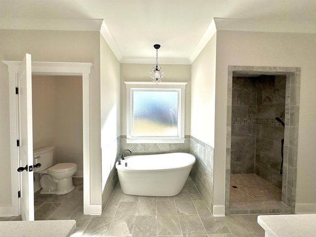 bathroom featuring ornamental molding, toilet, separate shower and tub, and tile walls