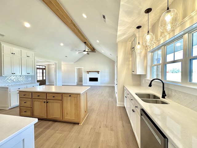 kitchen with pendant lighting, dishwasher, sink, and white cabinets