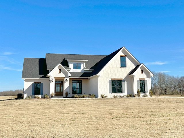 modern farmhouse style home with a front lawn