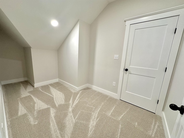 bonus room featuring lofted ceiling and light carpet