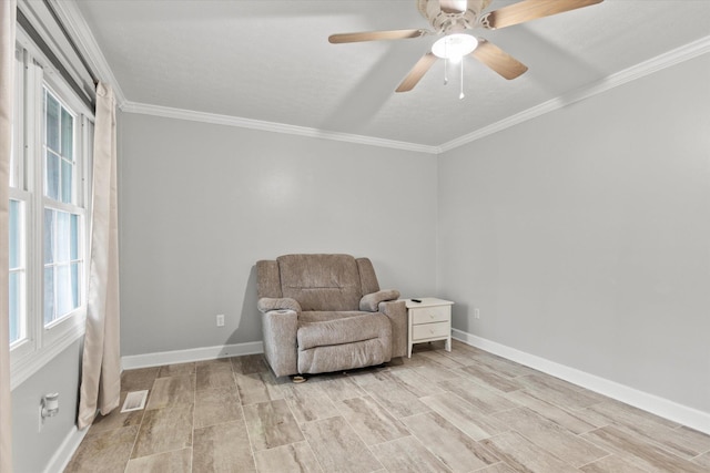  - sitting room with wood finish floors, baseboards, ornamental molding, and a ceiling fan