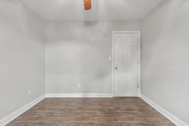  - unfurnished room with dark wood-style flooring, baseboards, and ceiling fan