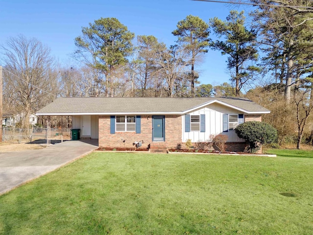 ranch-style home with concrete driveway, board and batten siding, a front yard, fence, and a carport