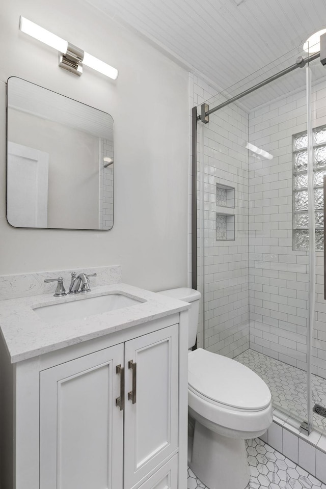 bathroom with vanity, toilet, tile patterned flooring, and a shower with door