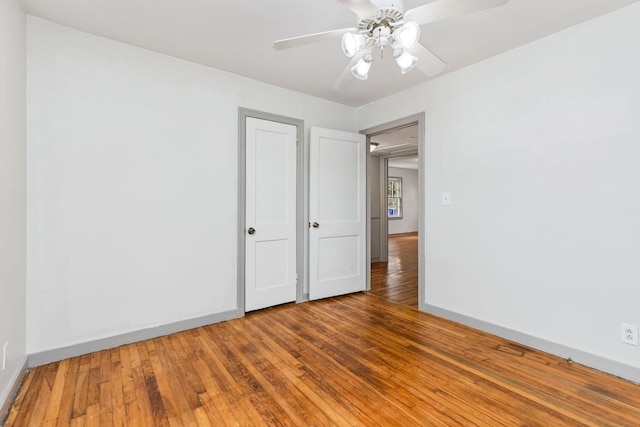 spare room with hardwood / wood-style flooring and ceiling fan