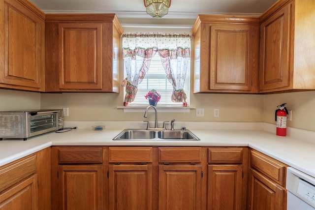  - kitchen with dishwasher, light countertops, and brown cabinetry