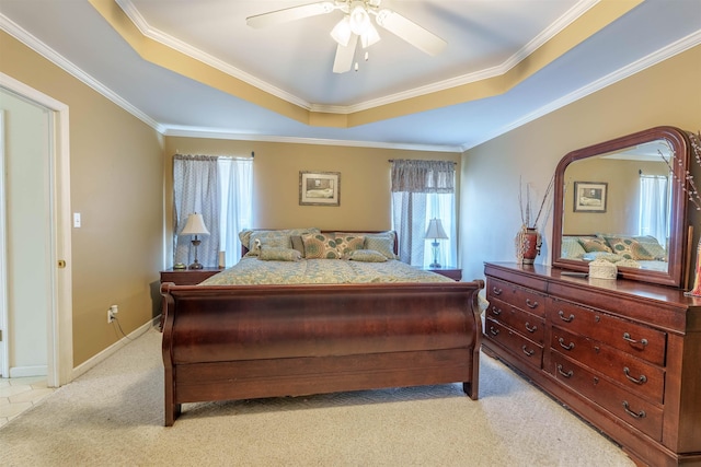  - bedroom featuring a raised ceiling, light carpet, ornamental molding, and a ceiling fan