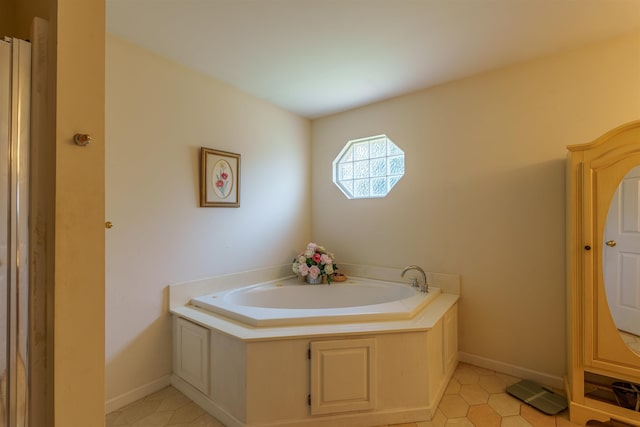  - bathroom featuring a bath and tile patterned floors