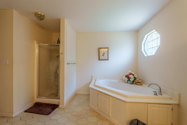  - bathroom featuring a bath and a stall shower