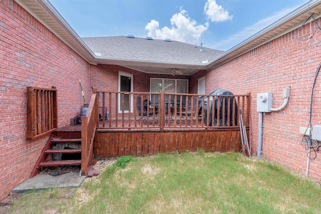  - rear view of property with brick siding, a deck, and roof with shingles