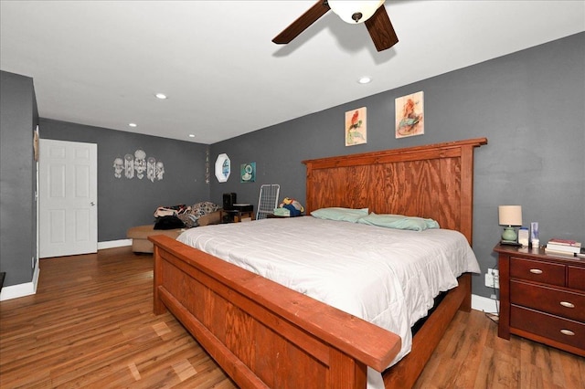 bedroom with ceiling fan and hardwood / wood-style flooring