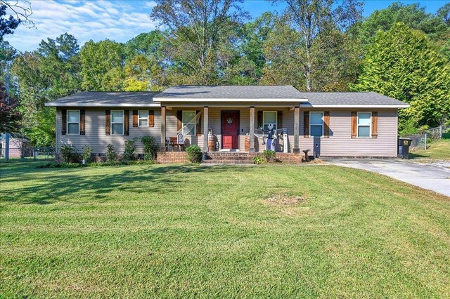 ranch-style home featuring a front yard and a porch