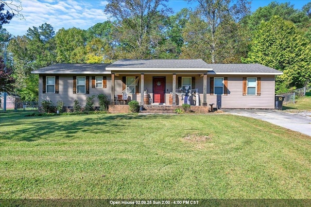 ranch-style home featuring a porch and a front lawn