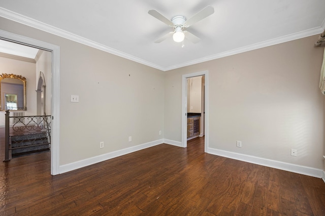 empty room featuring ceiling fan, dark hardwood / wood-style flooring, and ornamental molding