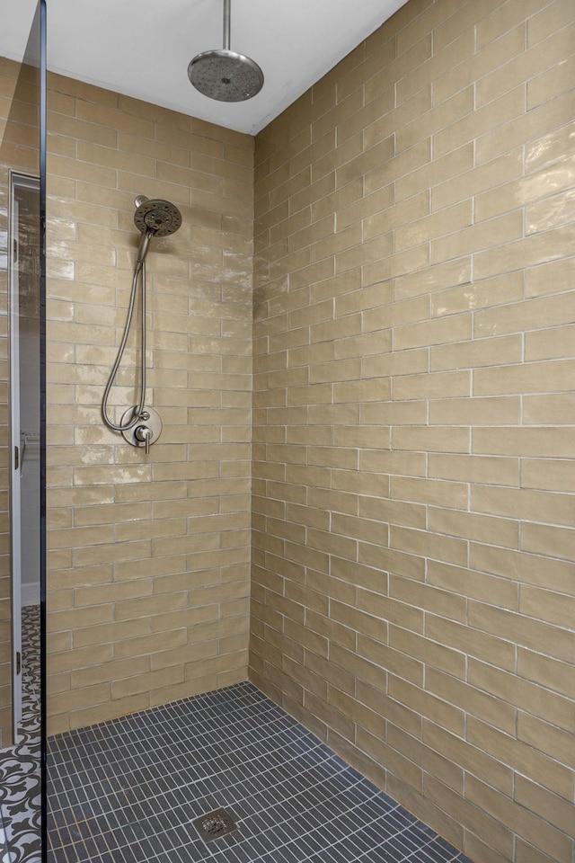 bathroom with a tile shower