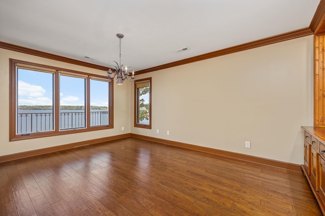 unfurnished dining area featuring a healthy amount of sunlight, a water view, ornamental molding, and a notable chandelier