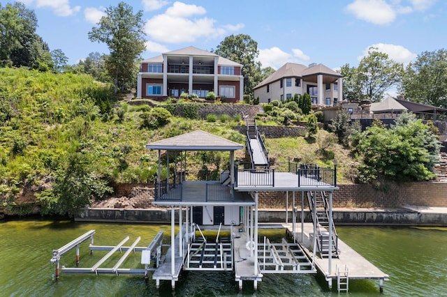 dock area with a water view and a balcony