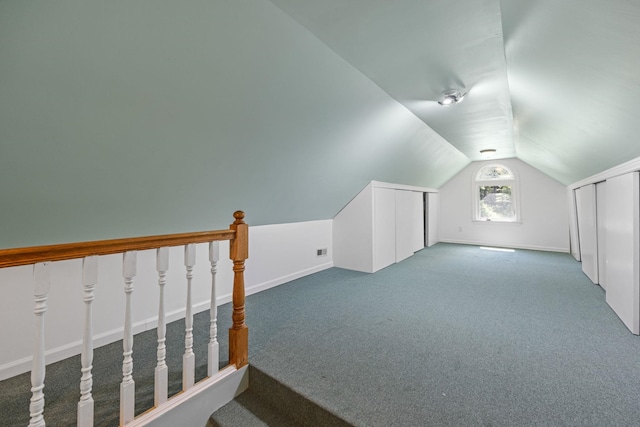 bonus room with carpet flooring and lofted ceiling