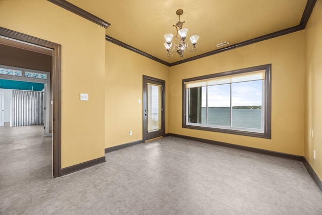 spare room with a water view, crown molding, and a notable chandelier