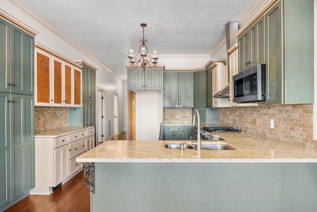 kitchen featuring pendant lighting, sink, dark hardwood / wood-style flooring, kitchen peninsula, and a chandelier