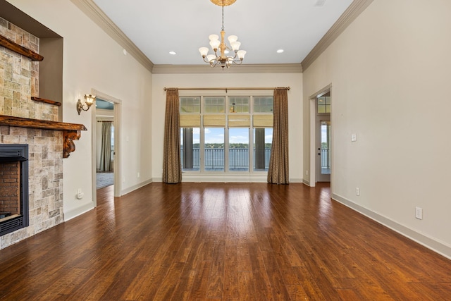 unfurnished living room with a chandelier, dark hardwood / wood-style flooring, a stone fireplace, and ornamental molding