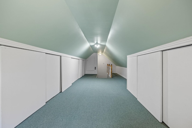 additional living space featuring lofted ceiling and light carpet