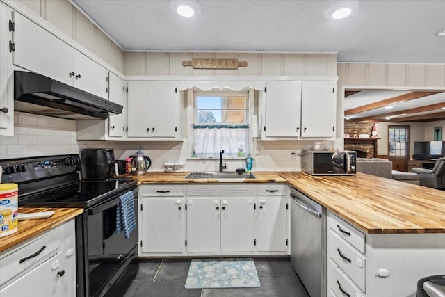 kitchen with wood counters, black electric range oven, sink, stainless steel dishwasher, and white cabinetry