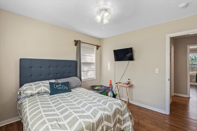 bedroom featuring multiple windows and dark hardwood / wood-style floors