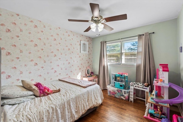 bedroom with ceiling fan and dark hardwood / wood-style flooring