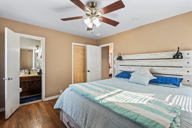 bedroom featuring ensuite bathroom, ceiling fan, dark wood-type flooring, sink, and a closet