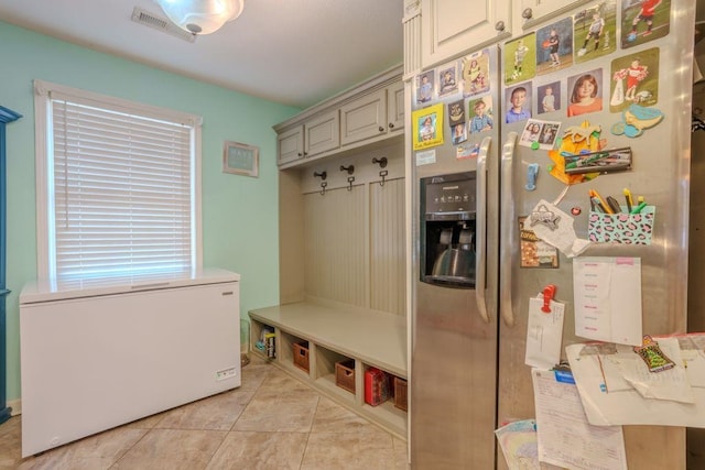 mudroom with light tile patterned floors