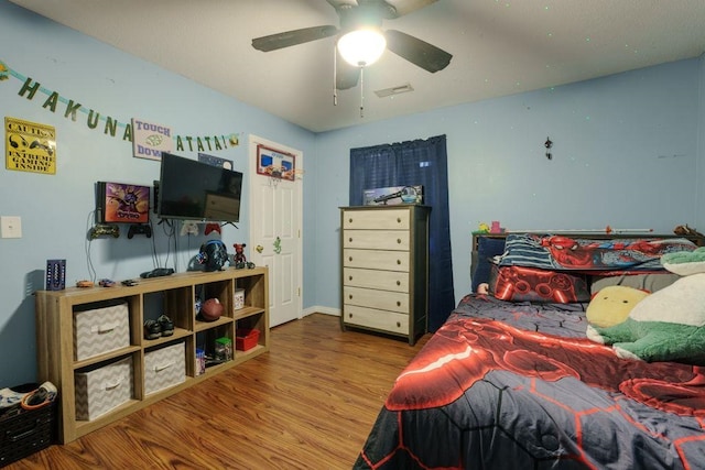 bedroom featuring ceiling fan and hardwood / wood-style flooring