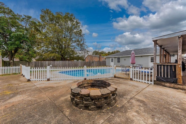 view of pool with a fire pit and a patio area