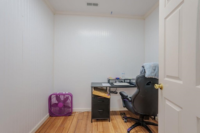 office with wood-type flooring and crown molding