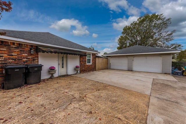 view of side of property with a garage and an outbuilding