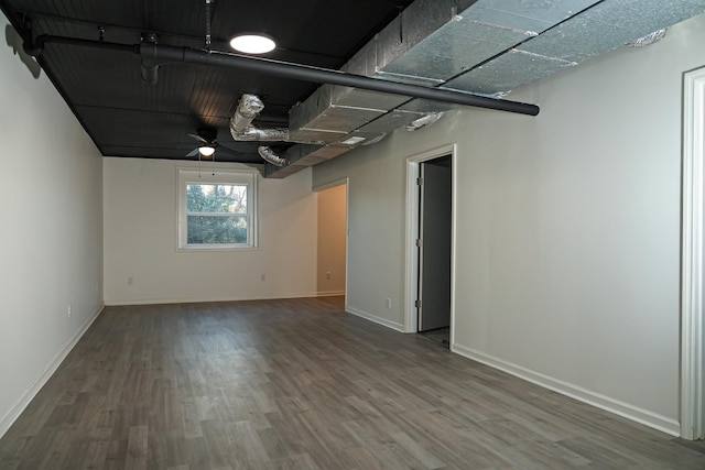 unfurnished room featuring wood finished floors and baseboards