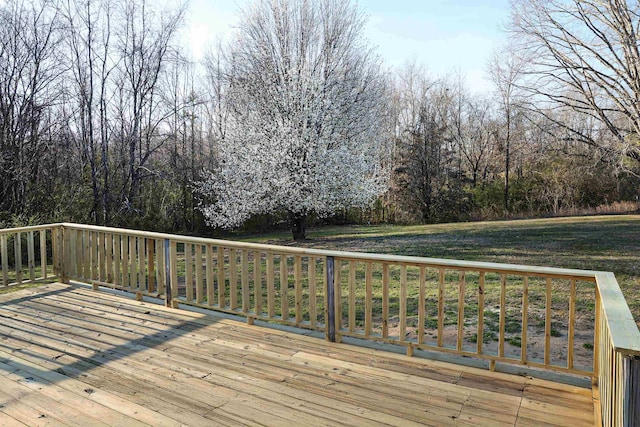 wooden terrace featuring a yard