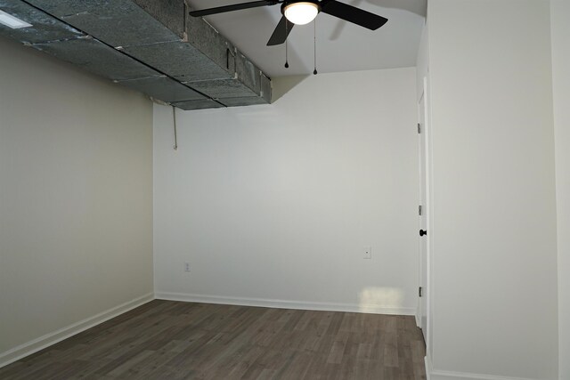 empty room featuring wood finished floors, baseboards, and ceiling fan