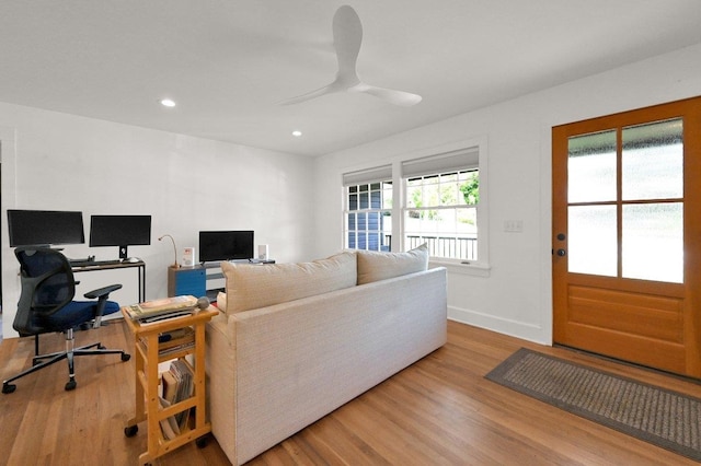 living room with ceiling fan and light hardwood / wood-style floors