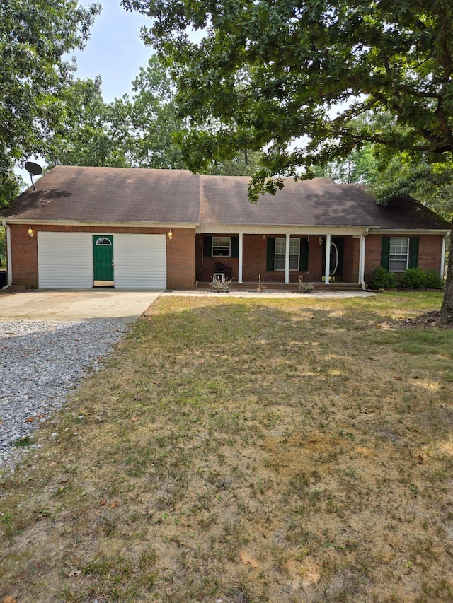 ranch-style home featuring a garage and a front lawn