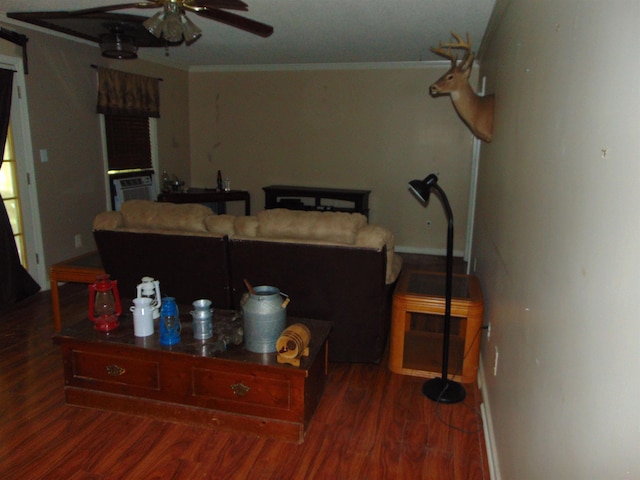 living room with ornamental molding, ceiling fan, and dark wood-type flooring