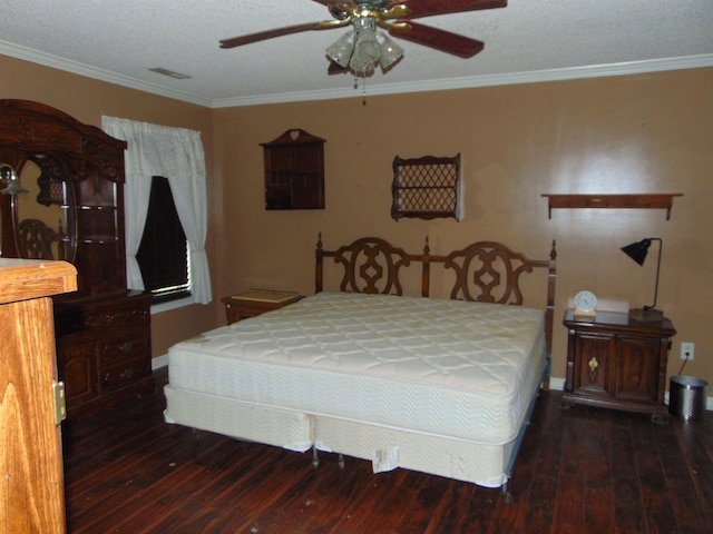 bedroom with a textured ceiling, ceiling fan, dark hardwood / wood-style floors, and ornamental molding