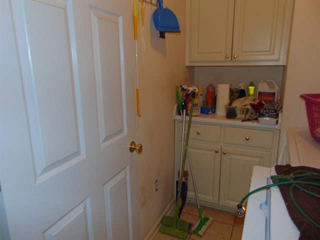 clothes washing area featuring light tile patterned floors