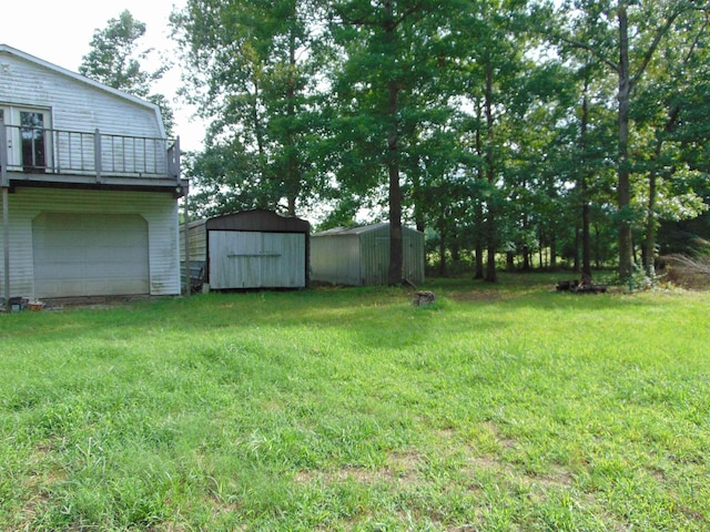 view of yard featuring a balcony and a shed