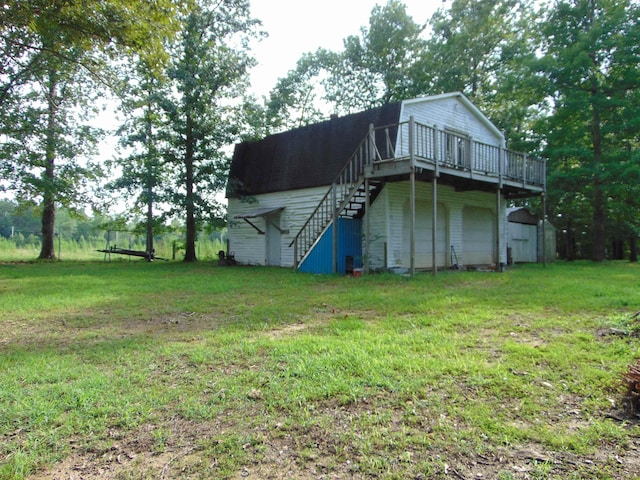 rear view of property with a deck and a lawn