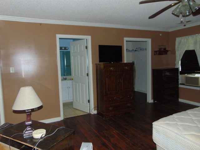 bedroom with ensuite bathroom, hardwood / wood-style floors, ceiling fan, and ornamental molding